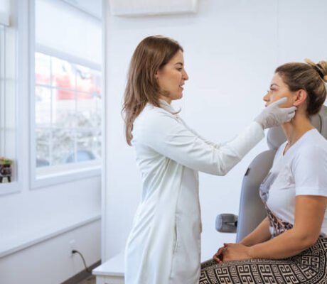 female dermatologist performing a procedure on a client