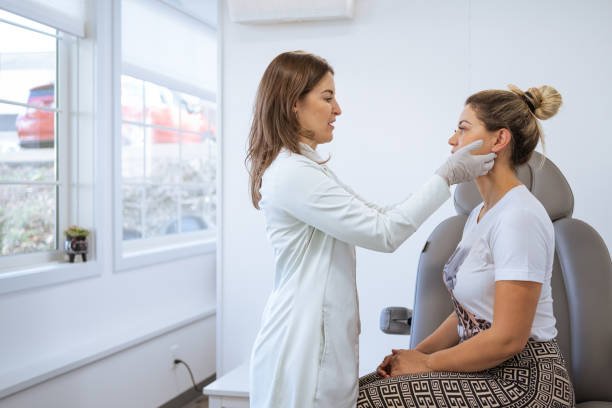 female dermatologist performing a procedure on a client